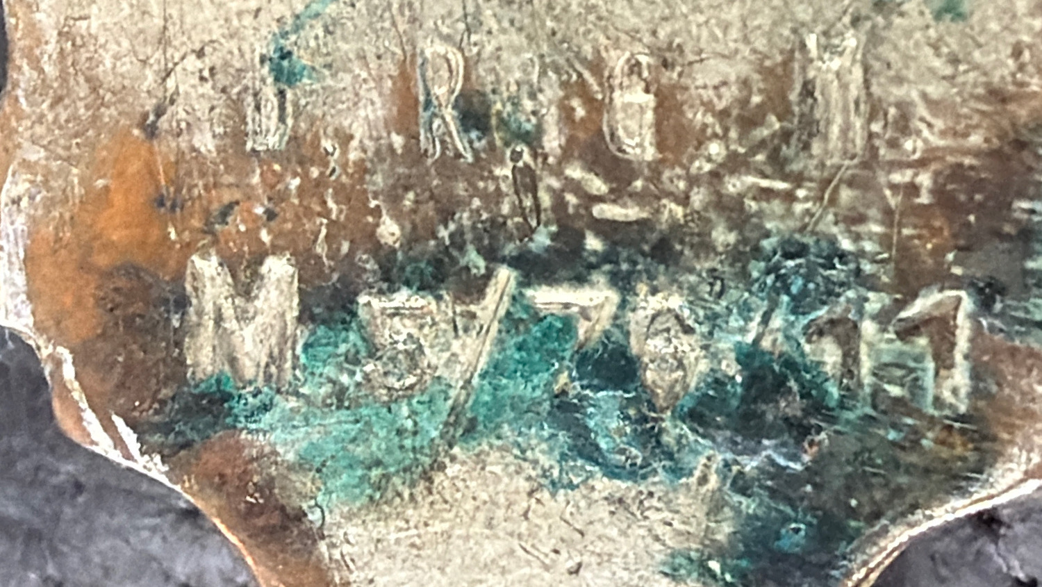 Close-up of the stamped wartime maker and fitting code on the original WW2 German flare pistol signal cartridge carrying case hardware.