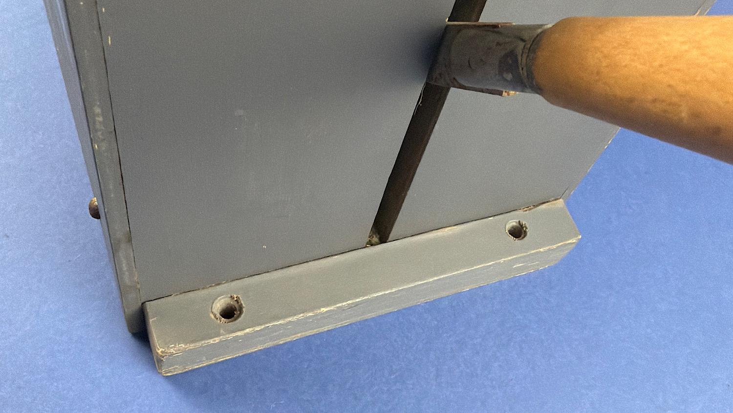 Close-up of the side-mounted operating lever and mounting base of a WW2 British gas mask filter sealing machine