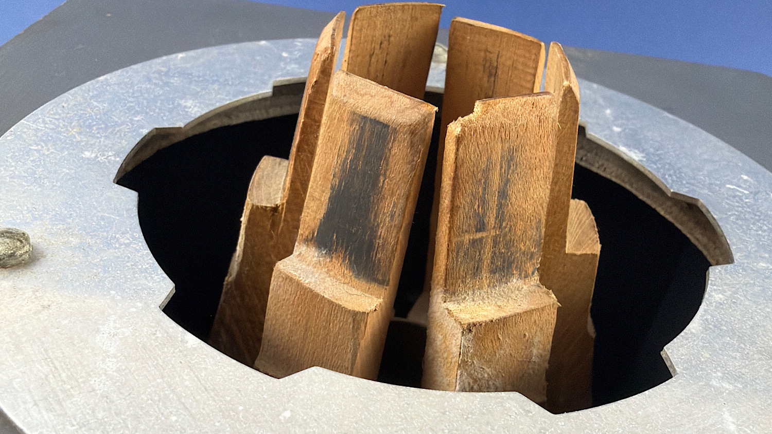 Close-up of the wooden clamping jaws and metal top plate of the WW2 British Home Front gas mask filter sealing machine