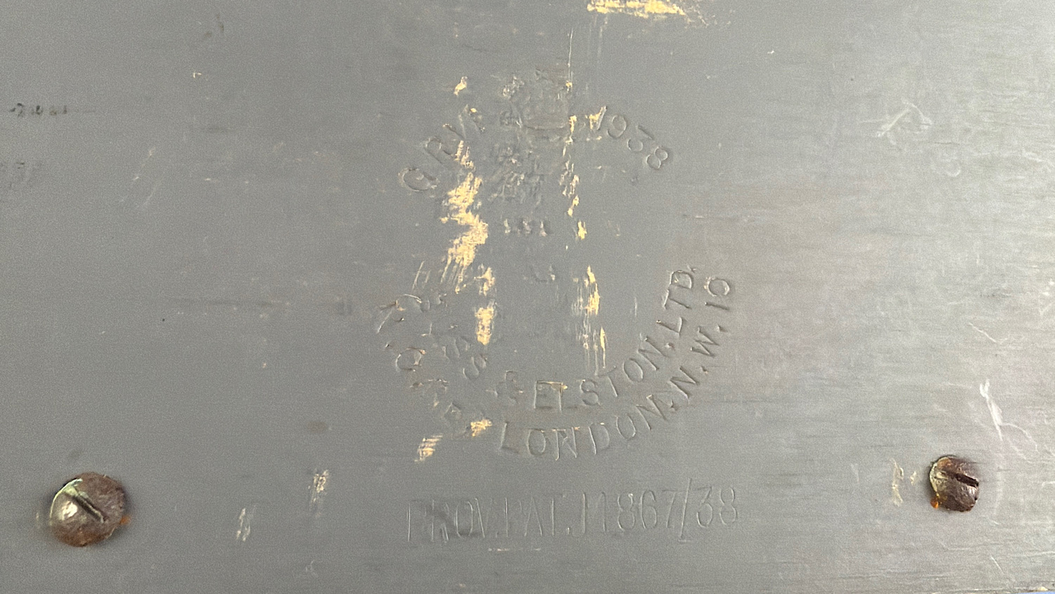 Maker’s and patent markings stamped into the grey-painted casing of the WW2 British gas mask filter sealing machine