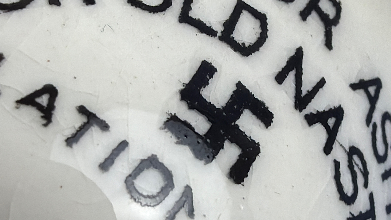 Close-up of the swastika motif and surrounding lettering on the WW2 British Fieldings anti-Hitler ashtray.